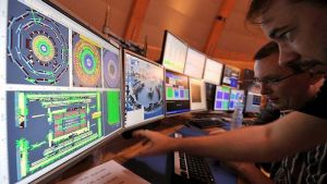 Pohled na experty sledující stopy pohybu částic v urychlovači LHC v CERN 